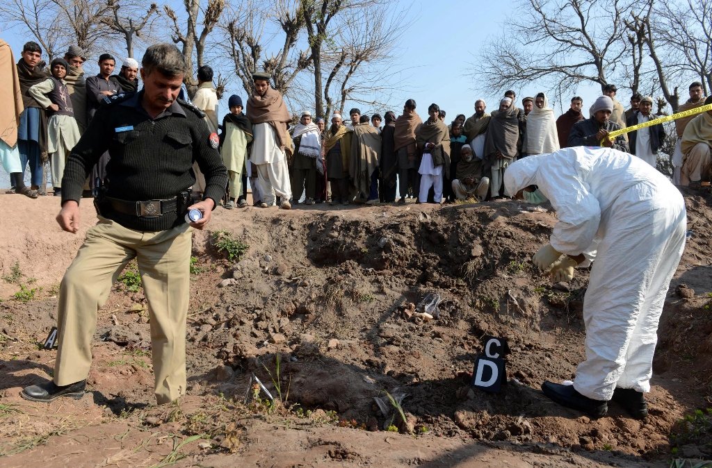 security officials inspect the site of attack by militants in peshawar on february 12 2014 photo afp