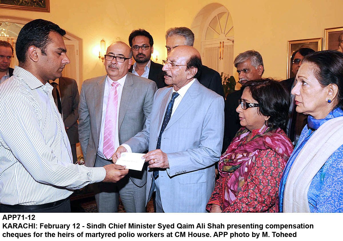 sindh chief minister qaim ali shah hands over compensation cheques to family members of those polio workers who were killed in karachi photo app