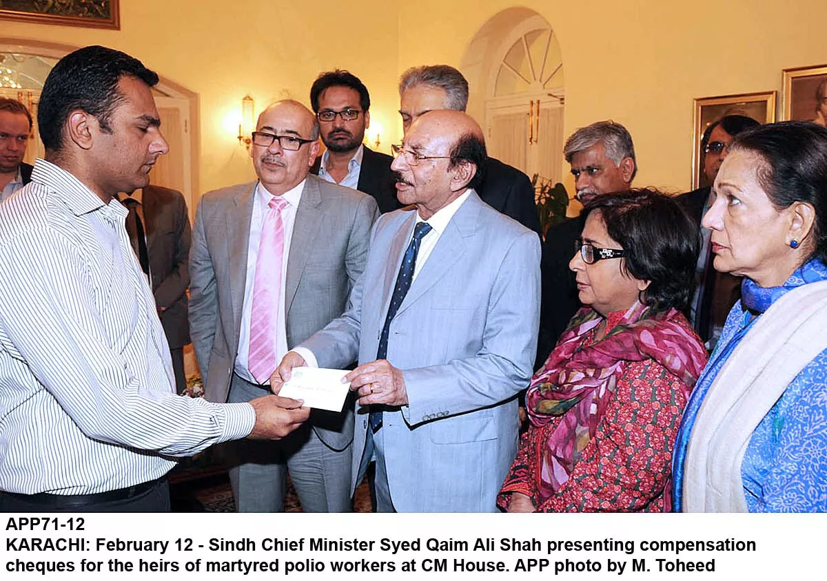sindh chief minister qaim ali shah hands over compensation cheques to family members of those polio workers who were killed in karachi photo app sindh chief minister qaim ali shah hands over compensation cheques to family members of those polio workers who were killed in karachi photo app