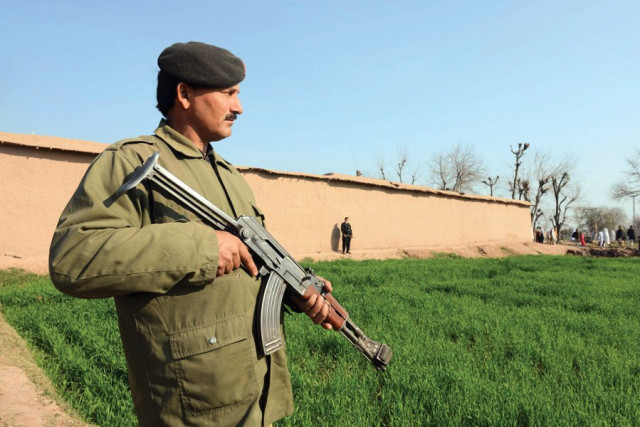 security personnel stand guard near the site of the attack by militants in masho khel village photo afp security personnel stand guard near the site of the attack by militants in masho khel village photo afp