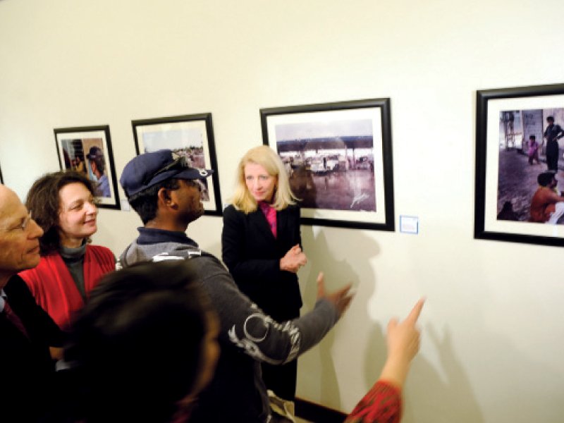 guests at the exhibition along with asf members listen appreciatively as a survivor explains his work photo express