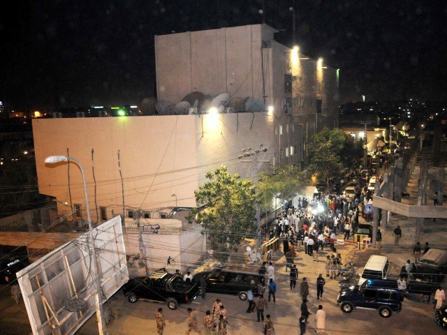 a crowd gathers at the front of the express news office after the attack on december 2 2013 photo express file