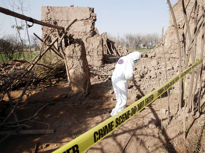 a member of the bdu collects evidence from the site of the attack in peshawar photo reuters