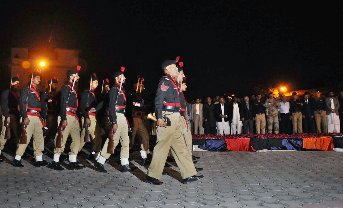 police officials march past coffins of their fallen comrades during their funeral in karachi on thursday evening photo mohammad noman express