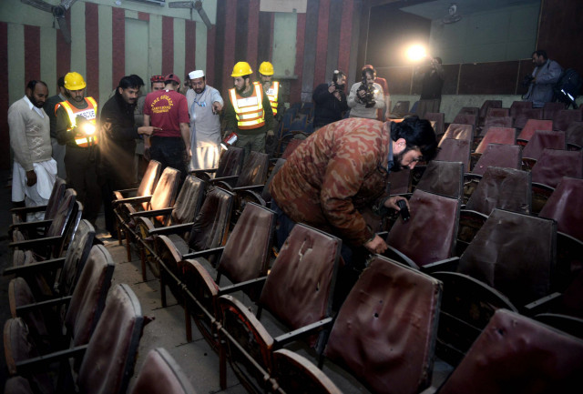 volunteers and rsecurity officials investigate the peshawar cinema after the attack photo afp volunteers and rsecurity officials investigate the peshawar cinema after the attack photo afp