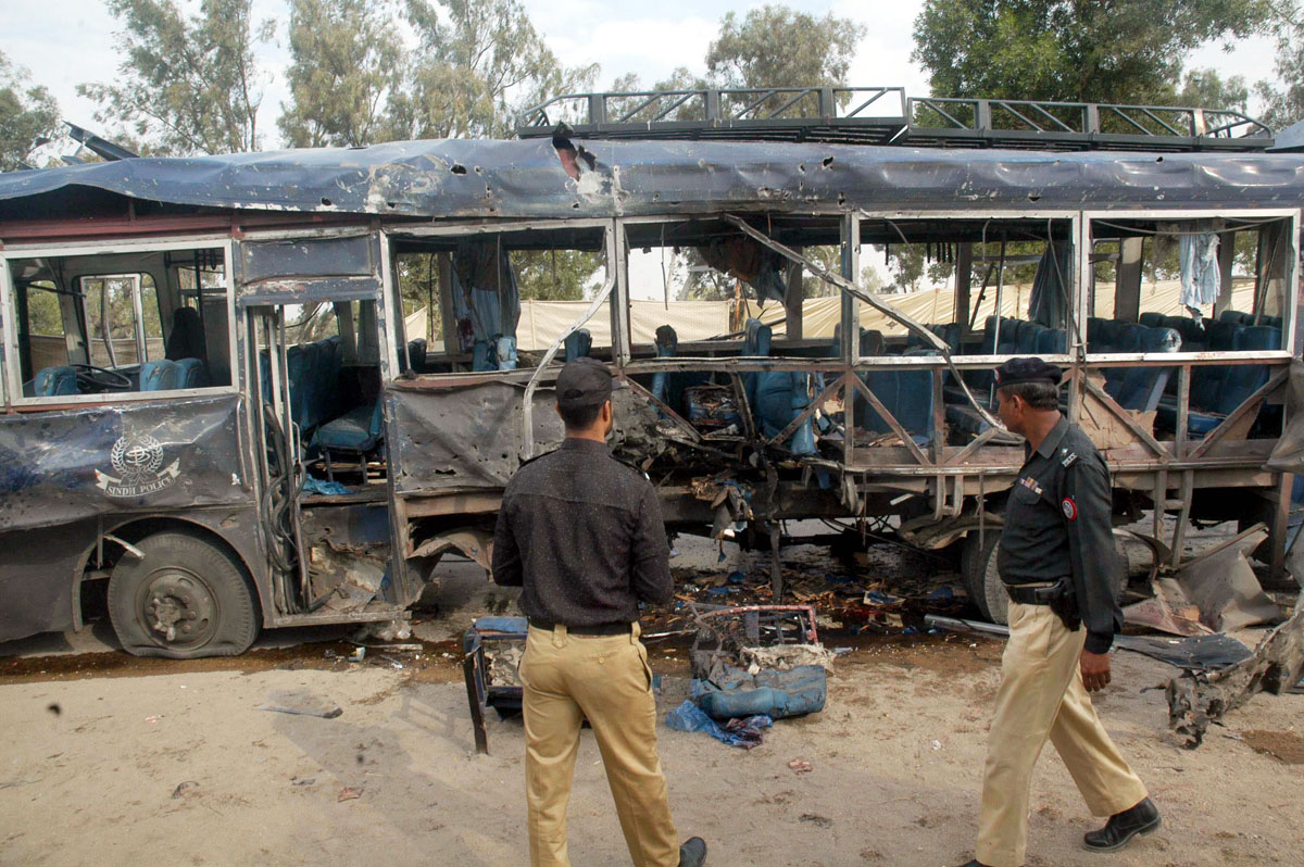 police officials walk past the bus which was attacked by a vehicle based ied photo rashid ajmeri express