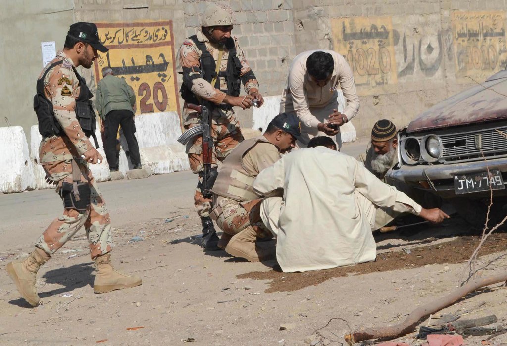 rangers officials collecting evidences the blast under the nazimabad no 7 flyover in karachi photo express rashid ajmeri