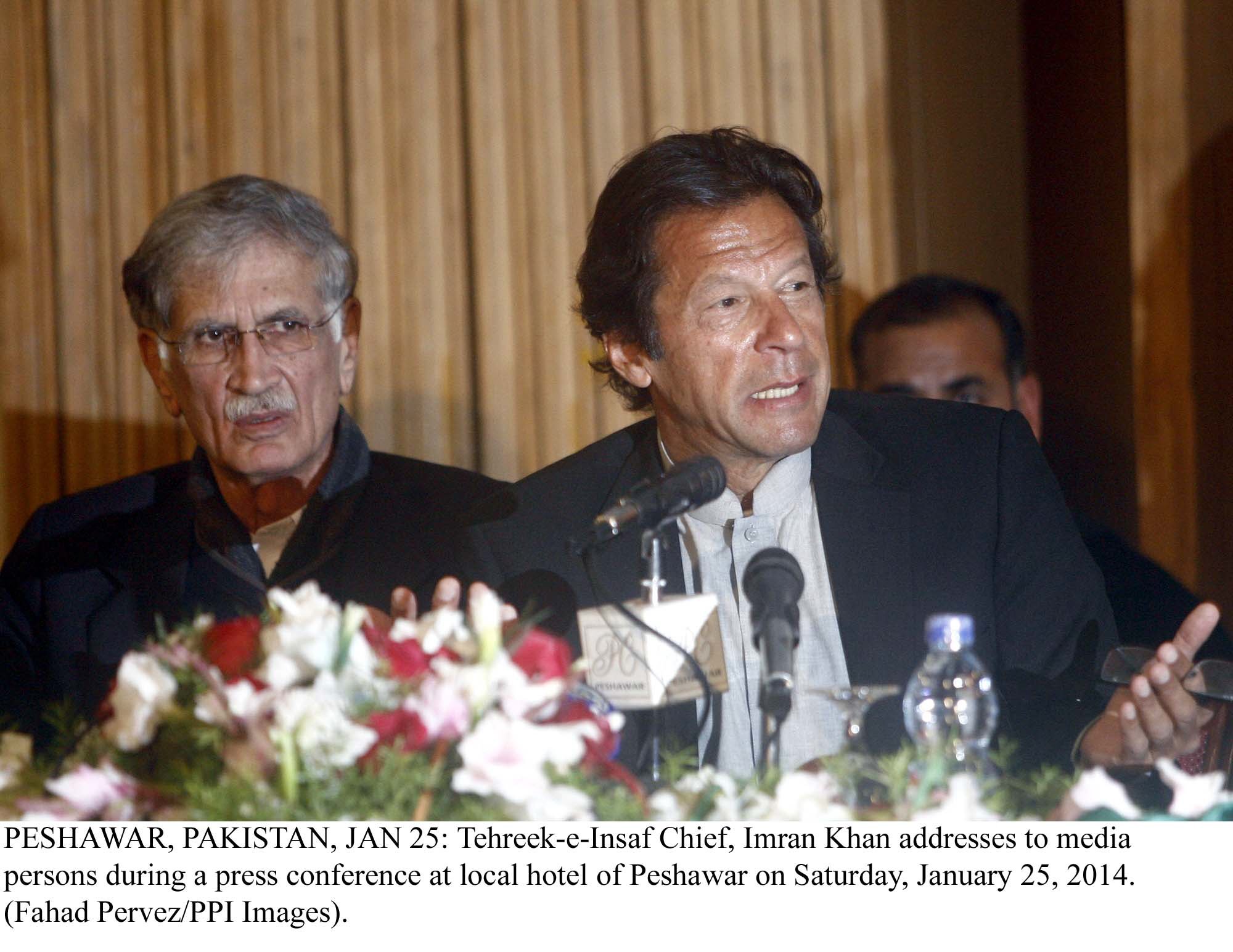 imran khan at a press conference in peshawar as khyber pakhtunkhwa chief minister pervez khattak watches on photo ppi