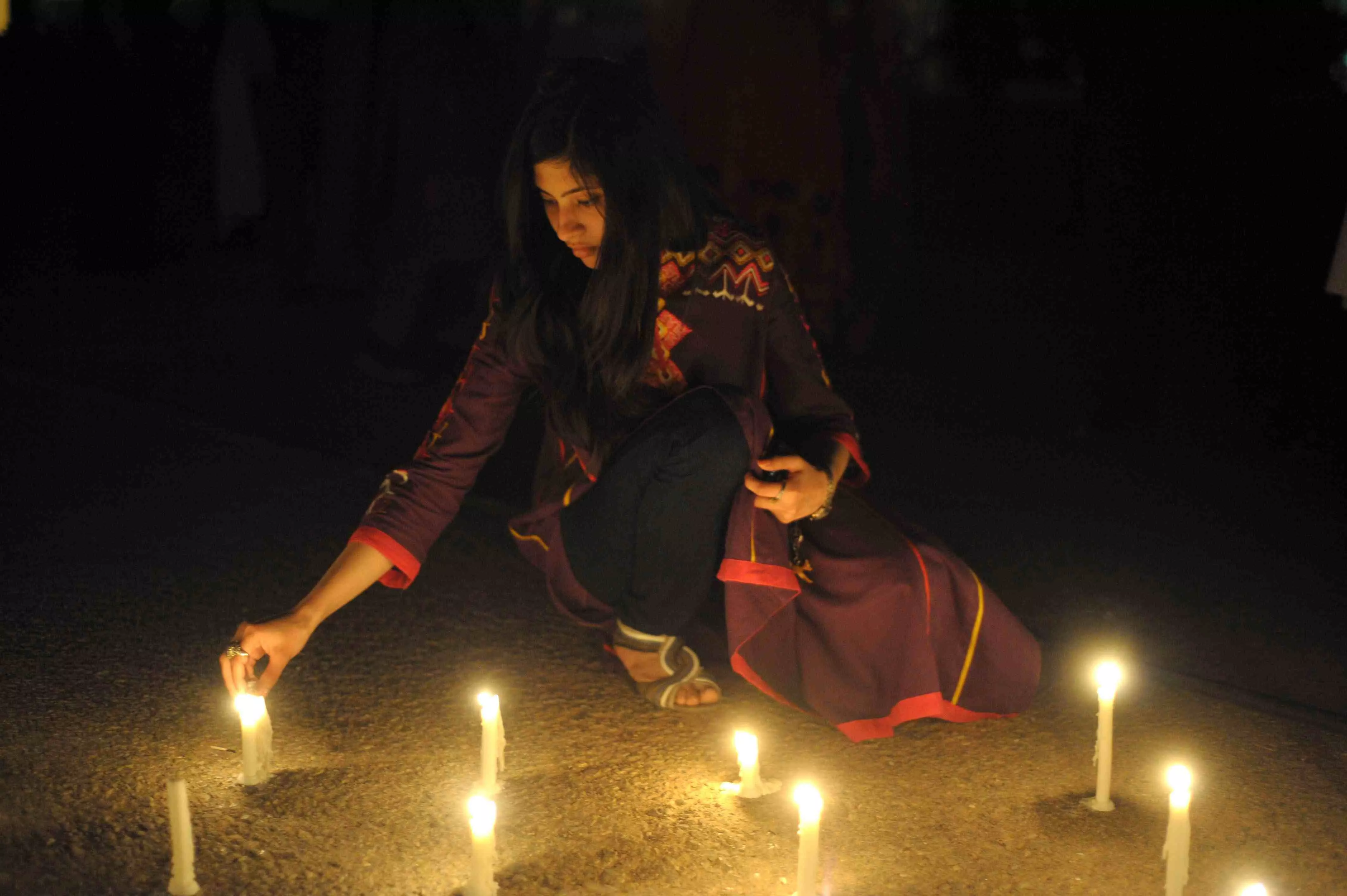 a pakistani girl lights candles in front of parliament house to mark the sixth global earth hour in islamabad on march 31 2012 photo afp a pakistani girl lights candles in front of parliament house to mark the sixth global earth hour in islamabad on march 31 2012 photo afp