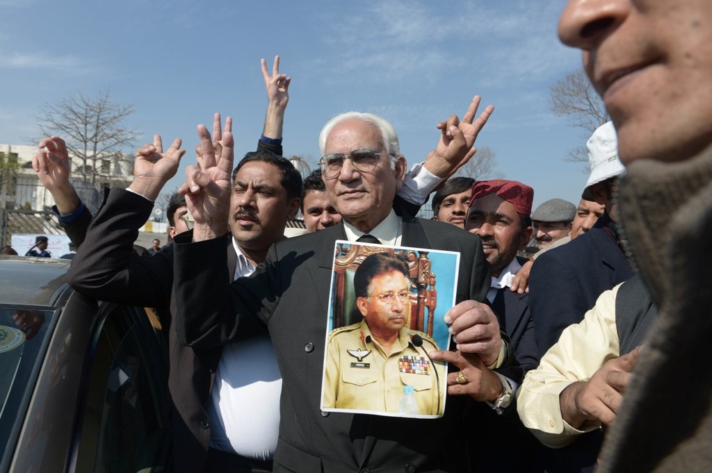 lawyer ahmed raza kasuri representing former president pervez musharraf makes a victory sign alongside supporters after musharraf 039 s case hearing in islamabad on february 18 2014 photo afp