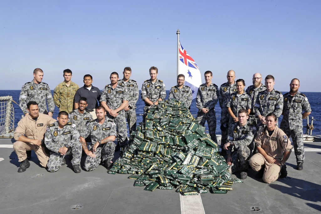 a handout photo released on february 18 2014 by the australian government department of defence shows hmas melbourne 039 s boarding party gathering around nearly two tonnes of hashish piled up on the ship 039 s flight deck following a successful narcotics inderdiction operation in the middle east area of operations photo afp