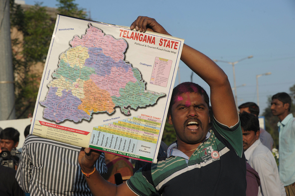 an indian supporter of telangana rastra samithi trs party holds a map as he celebrates the planned creation of telangana state in hyderabad on february 18 2014 photo afp