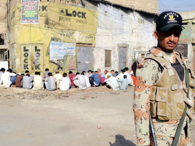 a rangers soldier standing on guard during an operation in lyari the paramilitary force denied its involvement in the missings persons case which was taken up by the shc on tuesday photo mohammad azeem express