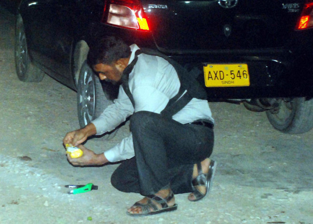 an official of the bomb disposal squad defuses an un exploded bomb found outside the offices of nawa i waqt on ma jinnah road on monday evening photo mohammad noman express an official of the bomb disposal squad defuses an un exploded bomb found outside the offices of nawa i waqt on ma jinnah road on monday evening photo mohammad noman express