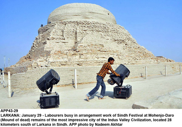 workers move heavy lights near the stupa of moenjo daro a world heritage site with metal pylons for the upcoming sindh festival visible in the background photo app workers move heavy lights near the stupa of moenjo daro a world heritage site with metal pylons for the upcoming sindh festival visible in the background photo app