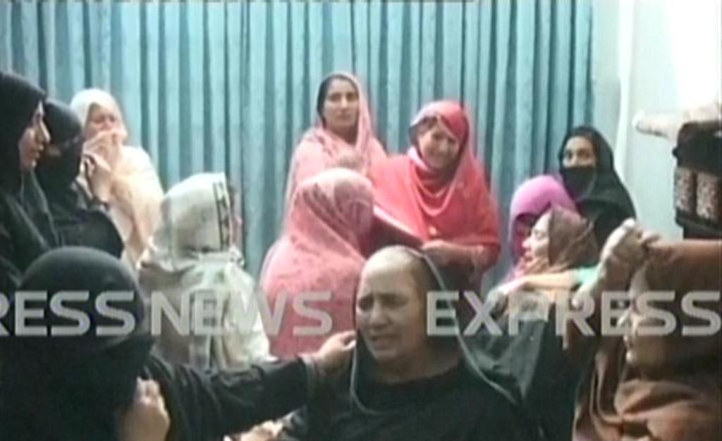 express news screengrab of family members mourning