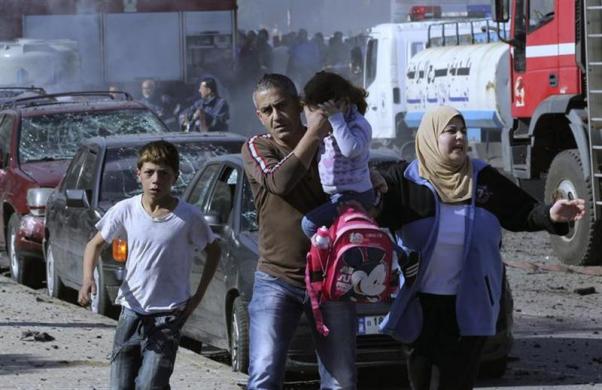 civilians run from the site of an explosion in the southern suburbs of beirut february 19 2014 photo reuters