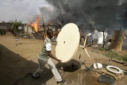 in this file photo a man tries to save his belongings during anti immigration clashes east of johannesburg south africa photo reuters file in this file photo a man tries to save his belongings during anti immigration clashes east of johannesburg south africa photo reuters file