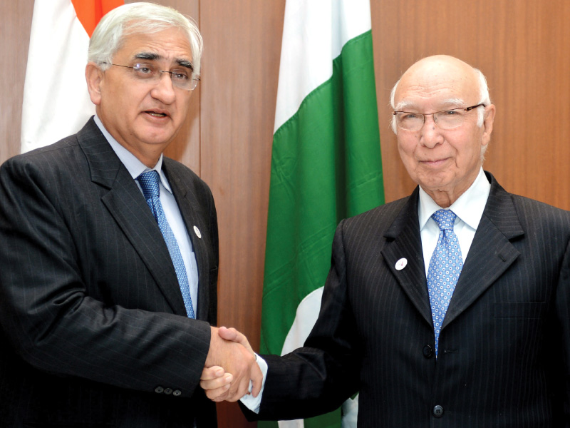adviser to pm on foreign affairs sartaj aziz and indian minister for external affairs salman khurshid that both countries would continue to work for the improvement in the bilateral relations photo afp file