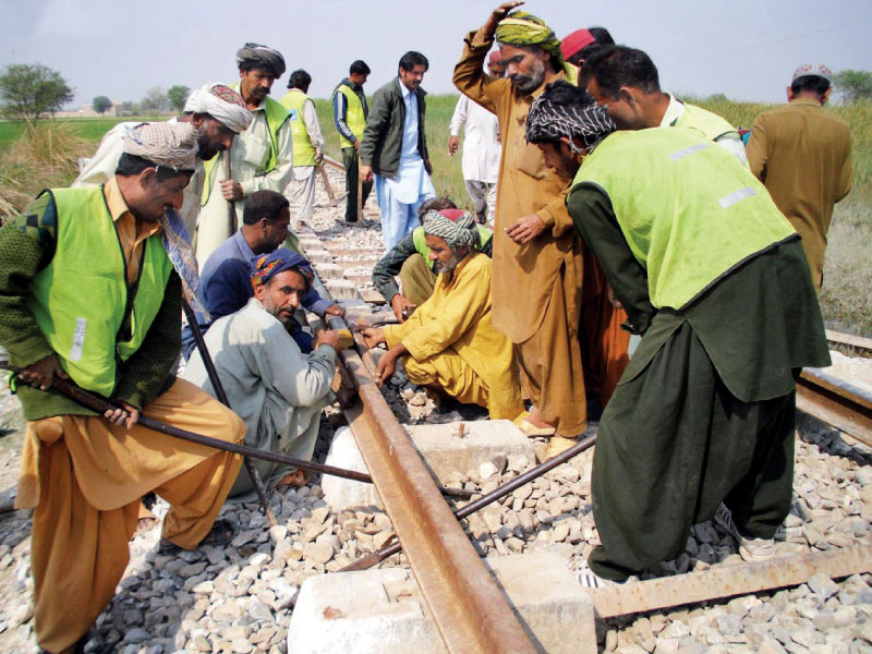 railway workers repairing the track that was damaged in the ied blast near mangoli railway station photo online