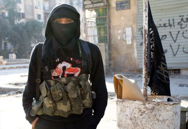 a member of fighter group al nusra front stands in a street of the northern syrian city of aleppo on january 11 2014 photo afp a member of fighter group al nusra front stands in a street of the northern syrian city of aleppo on january 11 2014 photo afp