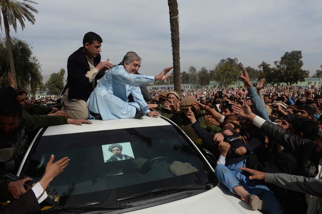 afghan presidential candidate abdullah abdullah c waves to supporters at an election rally in jalalabad photo afp