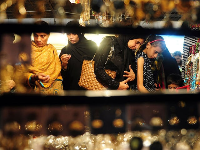 women in karachi shopping for jewellery at a market in preparation for eidul fitr photo afp