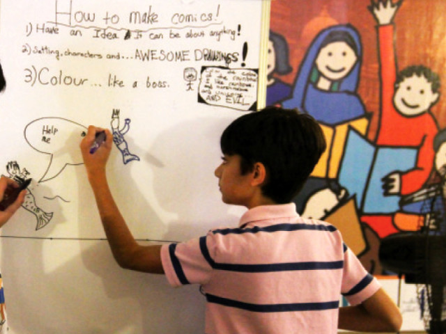 a young boy makes a comic strip at the children s literature festival right photo ayesha mir express a young boy makes a comic strip at the children s literature festival right photo ayesha mir express