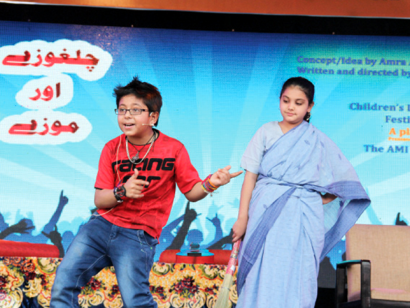 a young boy acting as kamil in the play titled chilghozay aur mozey dances while the character of his aunt looks at him photos ayesha mir express