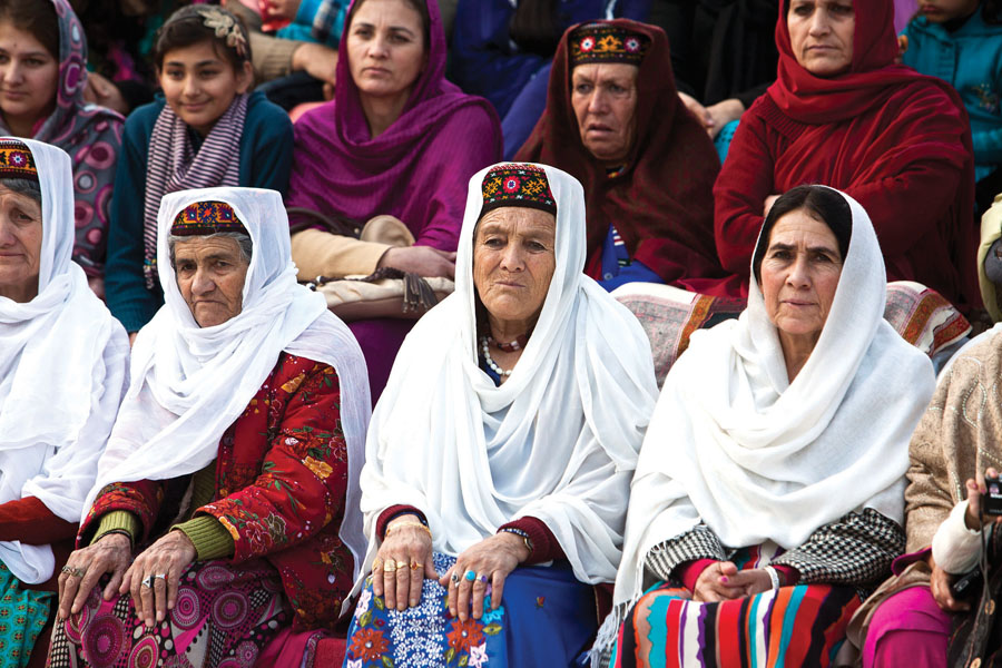 a man performing a sword dance left while members of the audience look on right photos myra iqbal express