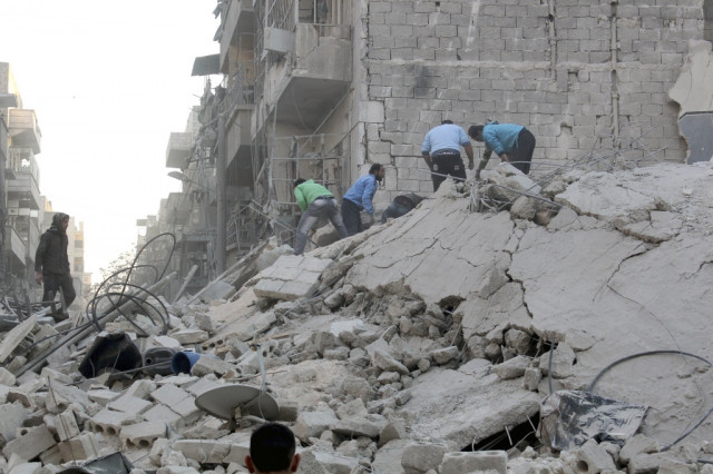 people stand on rubble of damaged buildings at a damaged site in syria photo reuters people stand on rubble of damaged buildings at a damaged site in syria photo reuters