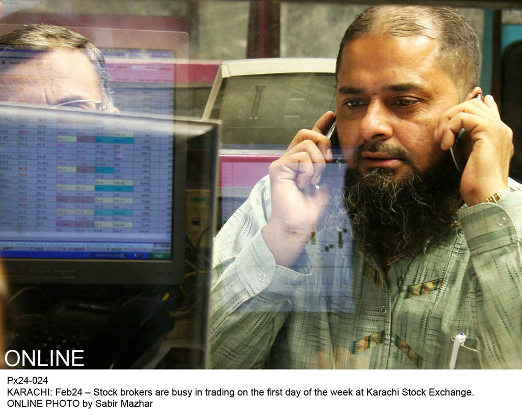 stock broker busy in trading on the first day of the week at kse on february 24 2014 photo online