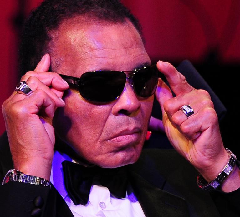 boxing legend muhammad ali adjusts his glasses on stage at muhammad ali 039 s celebrity fight night xviii on march 24 2012 in phoenix arizona photo afp