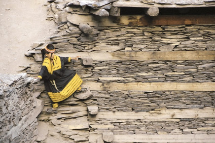 a girl precariously perched on stone ledges some houses here can be easily accessed via stairs while others can be reached only by scaling stone walls photos danial shah