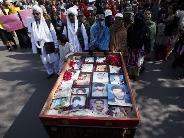 long march participants place portraits of their missing relatives on a push cart photo reuters