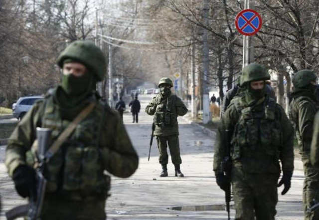 armed men patrol near the regional parliament building in the crimean city of simferopol march 1 2014 photo reuters armed men patrol near the regional parliament building in the crimean city of simferopol march 1 2014 photo reuters