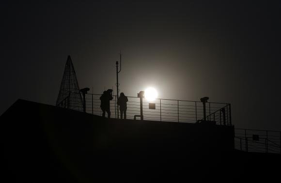 a visitor l looks towards the north through a pair of binoculars near the demilitarized zone separating the two koreas in paju 55 km 34 miles north of seoul photo reuters