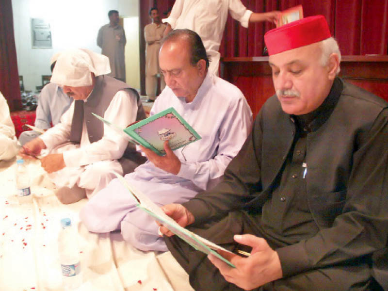 hussain recites the holy quran during the first death anniversary of his son mian rashid hussain held at nishtar hall peshawar on july 25 2011 photo ppi