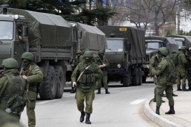 armed servicemen wait near russian army vehicles outside a ukrainian border guard post in the crimean town of balaclava march 1 2014 photo reuters armed servicemen wait near russian army vehicles outside a ukrainian border guard post in the crimean town of balaclava march 1 2014 photo reuters