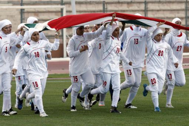 iranian women footballers run with the national flag at a stadium in amman moments after they were barred from playing an olympic qualifier against jordan for wearing the headscarf photo afp iranian women footballers run with the national flag at a stadium in amman moments after they were barred from playing an olympic qualifier against jordan for wearing the headscarf photo afp