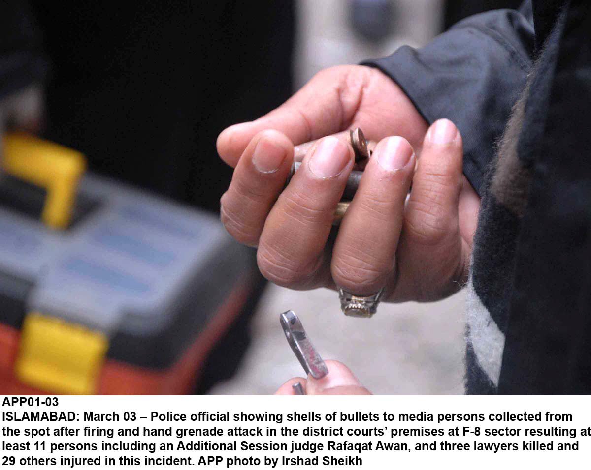 a police official holds up bullet casings photo app file