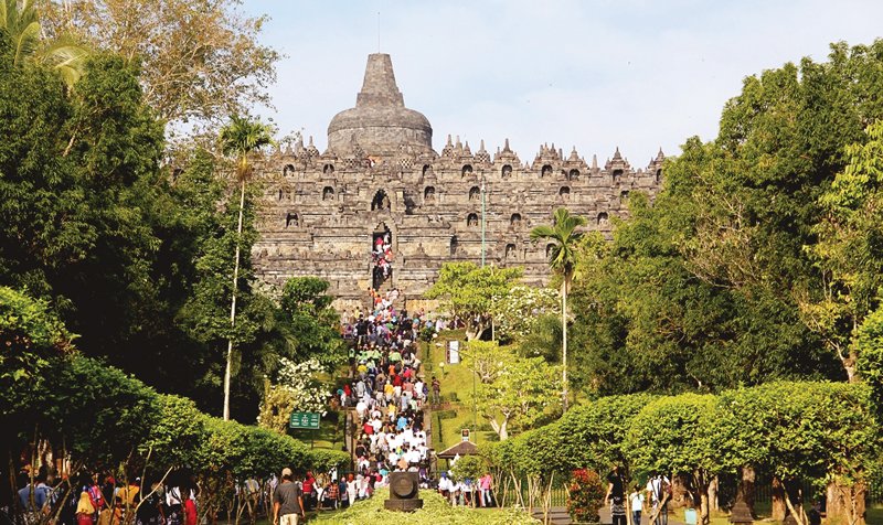 tourists and pilgrims are ascending to the top platform of borobudur temple by its main entrance which is on the eastern side photos fazal khaliq