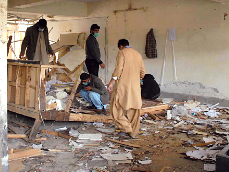 investigators sifting through the rubble in one of the damaged rooms in the district courts photo online