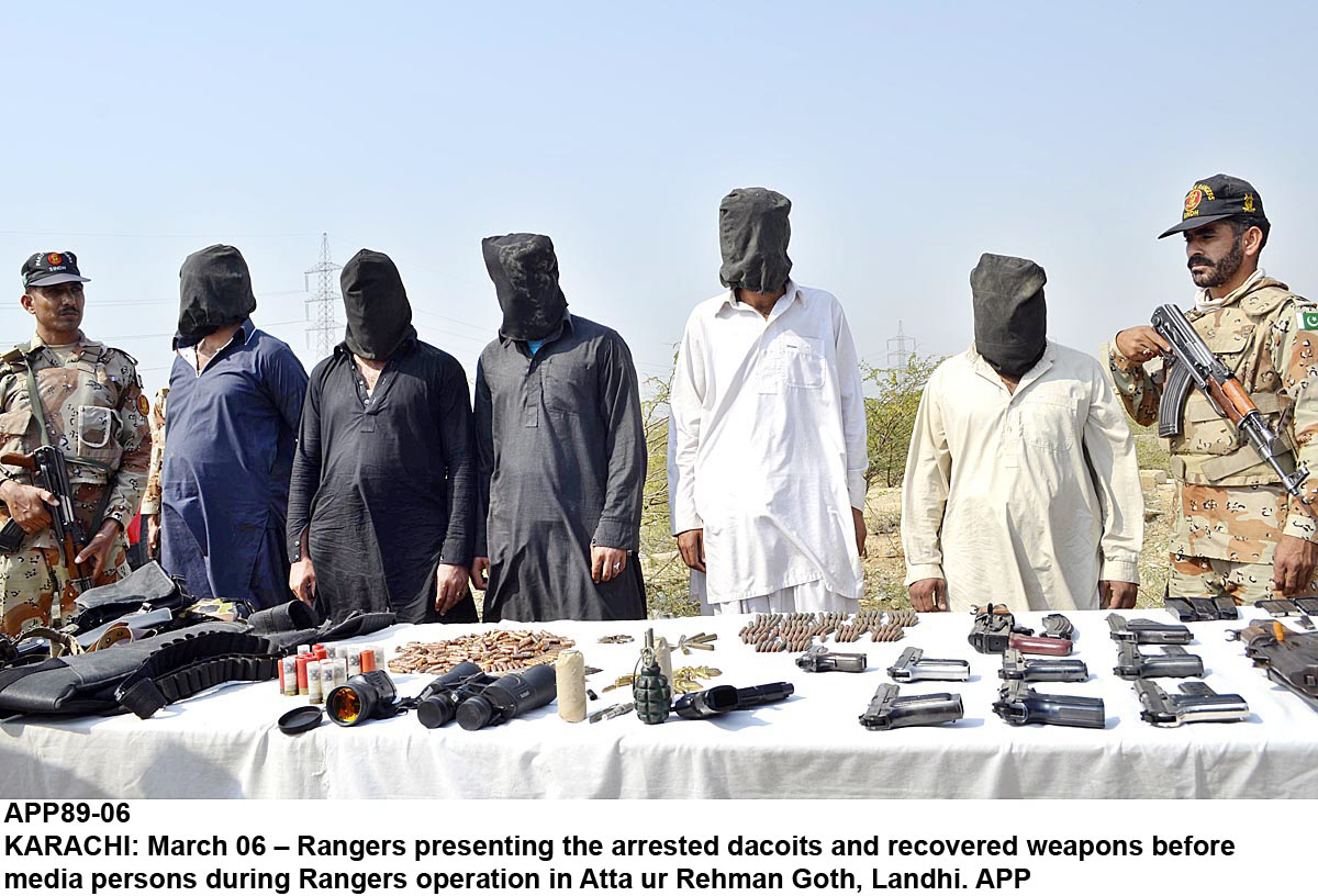 rangers personnel stand guard next to some of the suspects caught in their raids and the booty recovered photo app