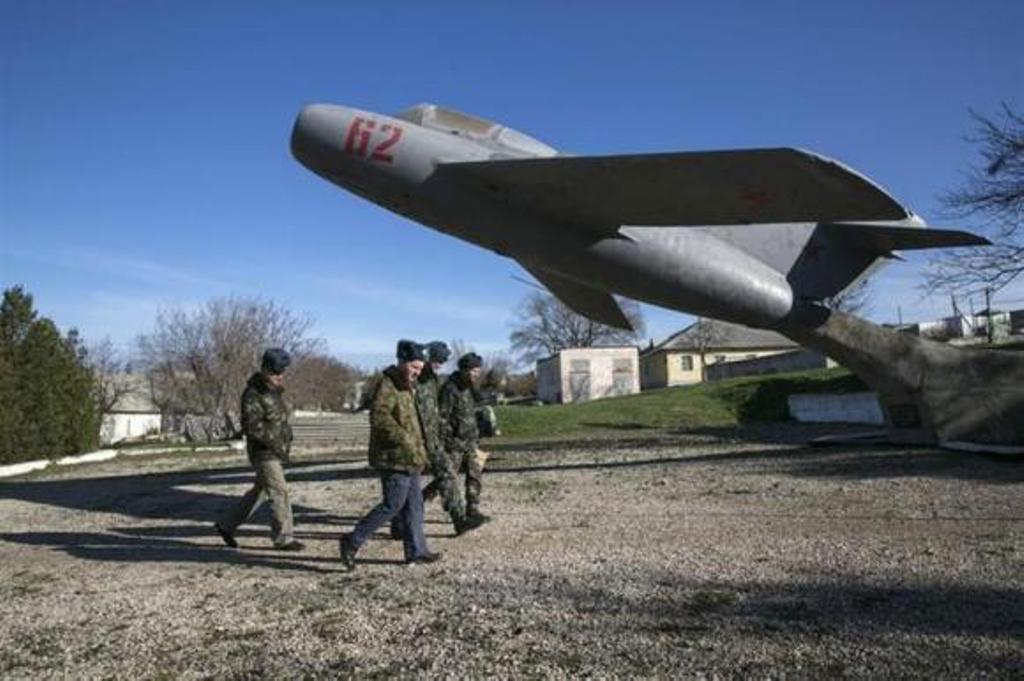 ukrainian servicemen walk on the territory of a military unit located in the village of lyubimovka near a local airfield southwest of simferopol crimea 039 s capital photo reuters