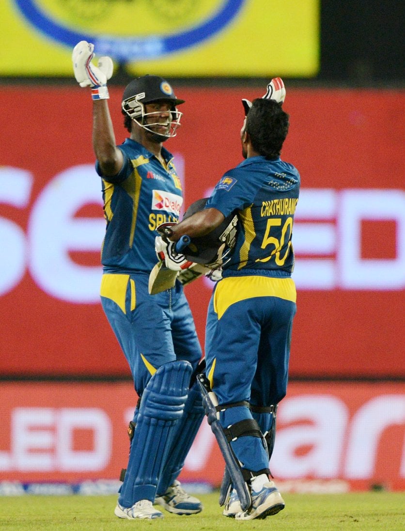 sri lankan cricket captain angelo mathews l celebrates with his teammate chaturanga de silva r after winning the final match of the asia cup one day cricket tournament between pakistan and sri lanka at the sher e bangla national cricket stadium in dhaka on march 8 2014 photo afp