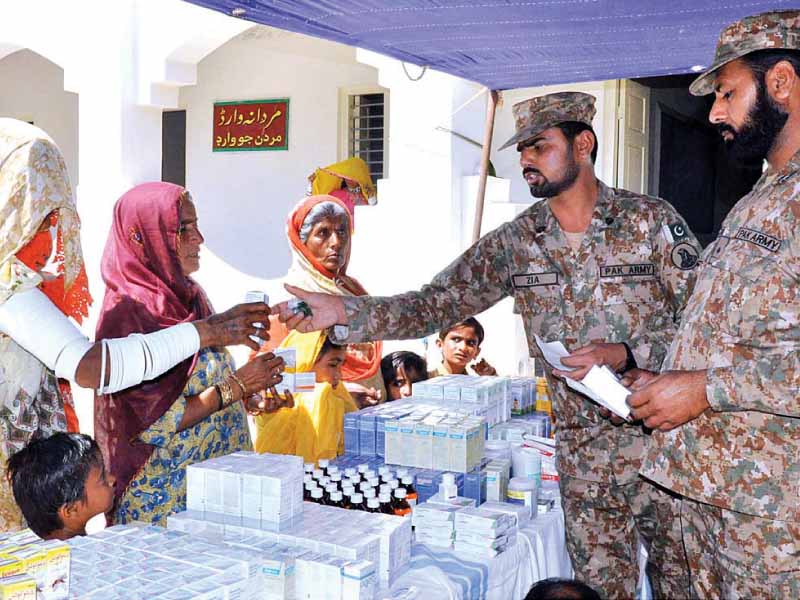 army personnel distributing free medicines at a camp in thar photo app