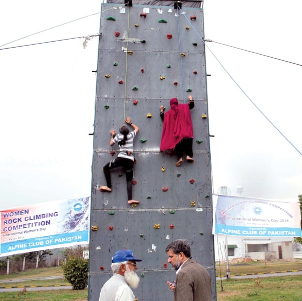 girls climbing the boulder wall photo express