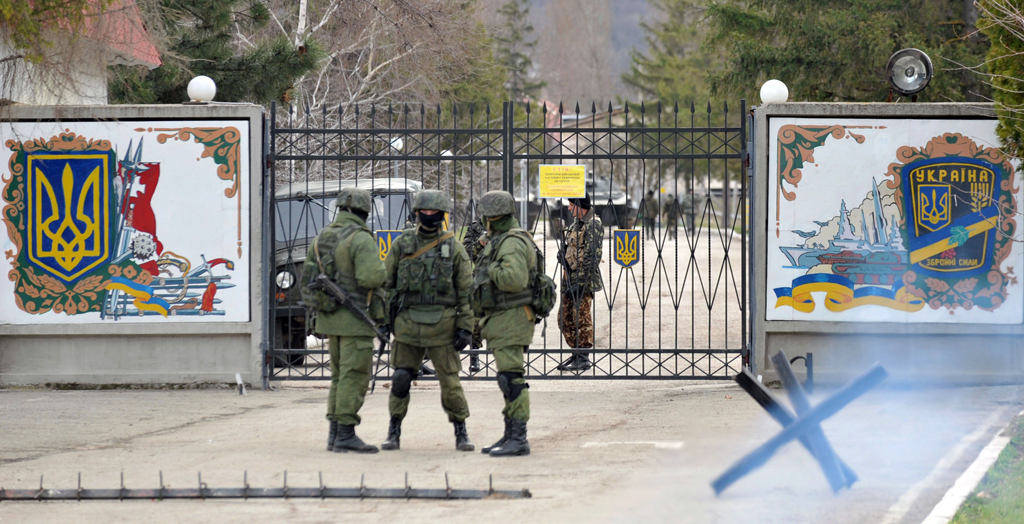 ukrainian soldiers r stand guard inside their base blocked by russian troops in perevalnoye near simferopol on march 6 2014 photo afp