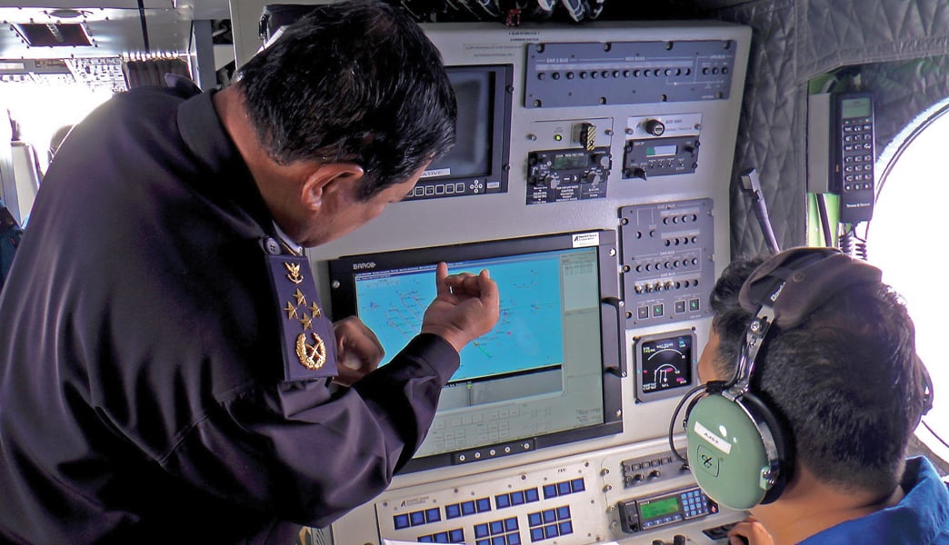 malaysian maritime enforcement personnel scan for the missing plane photo afp